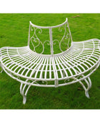 White metal bench with decorative backrest on a grassy background