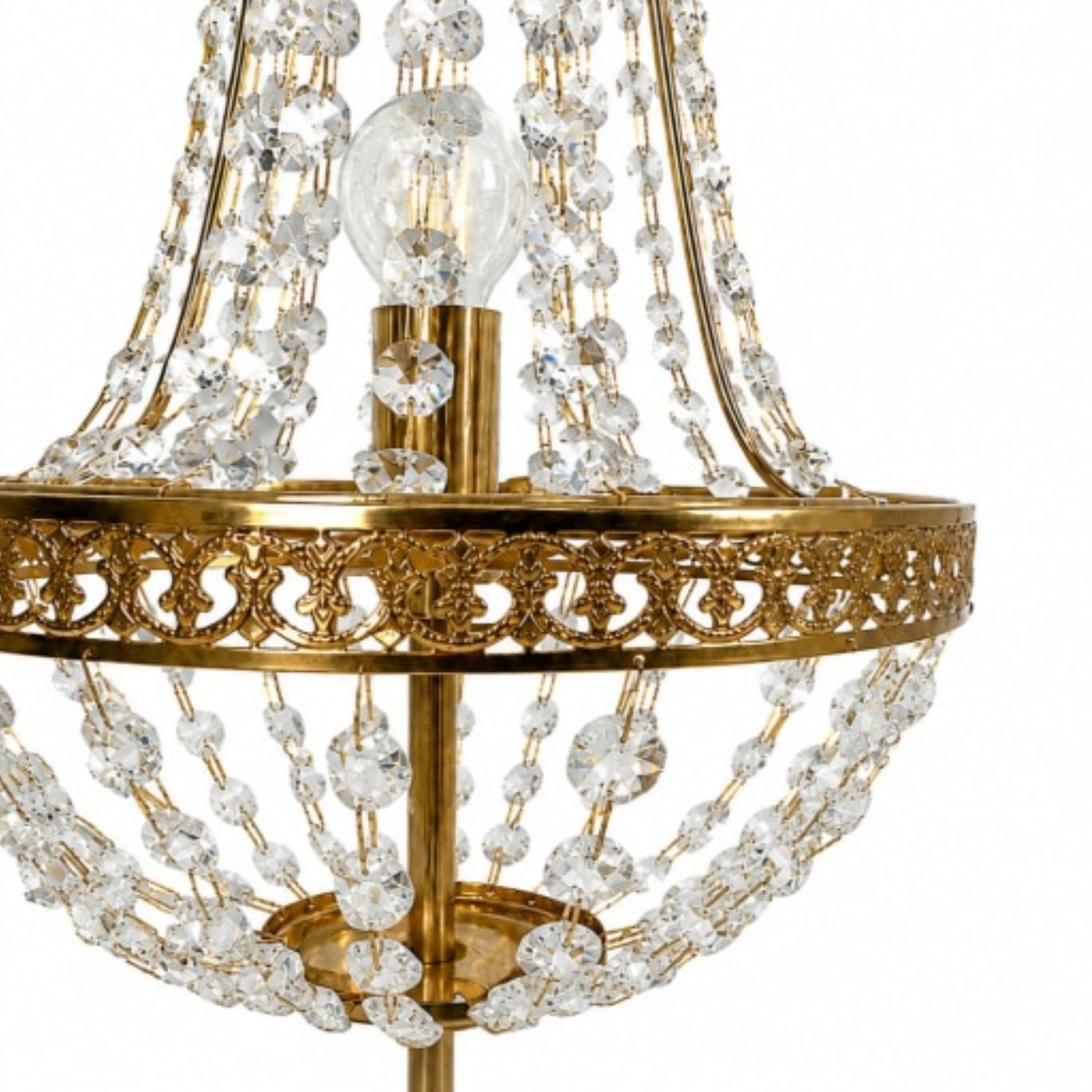 Close-up of a gold-finished chandelier with clear crystal bead strands and a visible light bulb, shown against a plain white background.