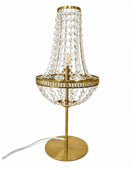 A gold-finished table lamp with a crystal bead chandelier-style shade, a circular crystal bowl, and a round base on a white background.
