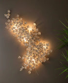 Decorative wall light fixture with floral design on a wooden panel background
