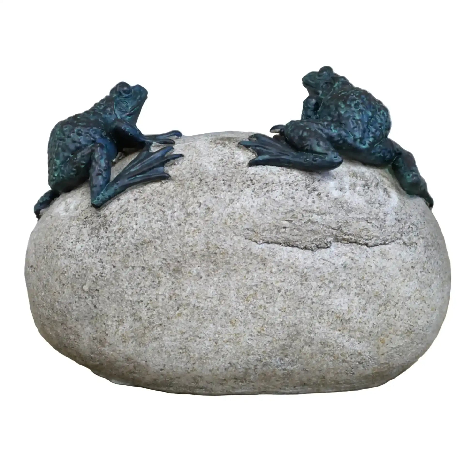 Two frog sculptures on a large stone with a blurred natural background