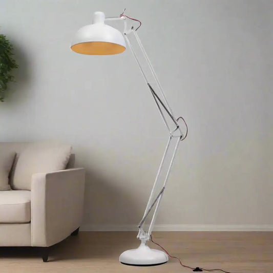 White floor lamp with a clear arm in a room with a beige sofa and a plant.