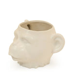Ceramic mug shaped like a monkey's head on a white background