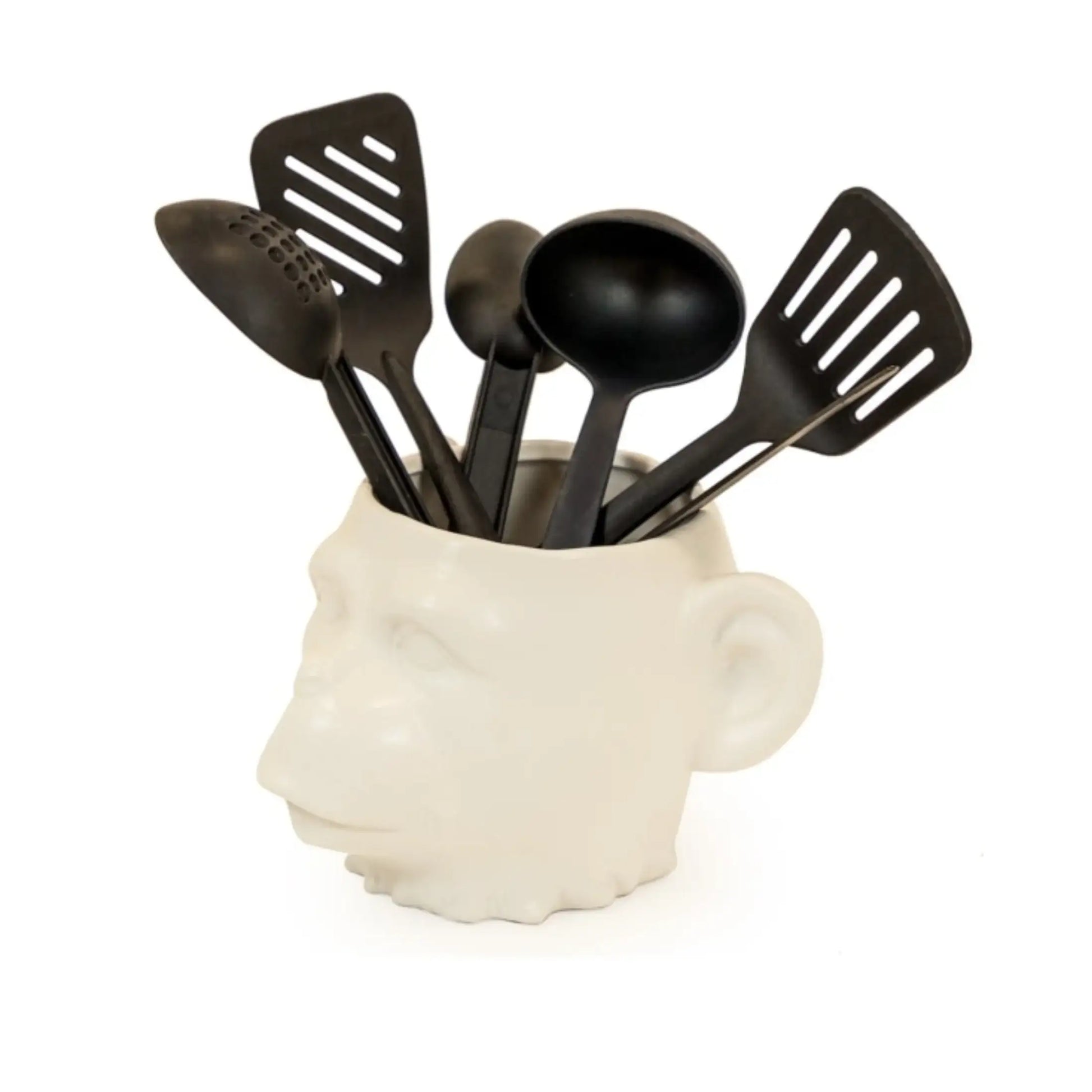 White head-shaped kitchen utensil holder with black utensils on a white background