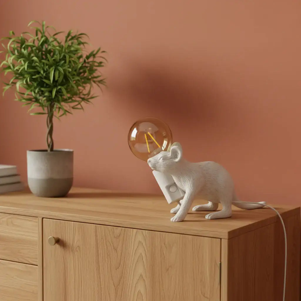 White cat-shaped phone holder with a lit candle on a textured surface