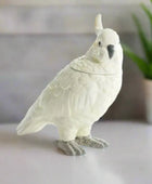 Ceramic parrot-shaped cookie jar on a white background