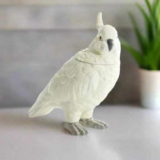 Ceramic parrot-shaped cookie jar on a white background
