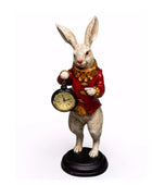 Decorative figurine of a rabbit in a red coat holding a clock on a white background