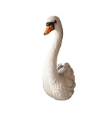 White swan figurine on a white background