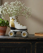 Decorative roller skate with flowers on a wooden surface