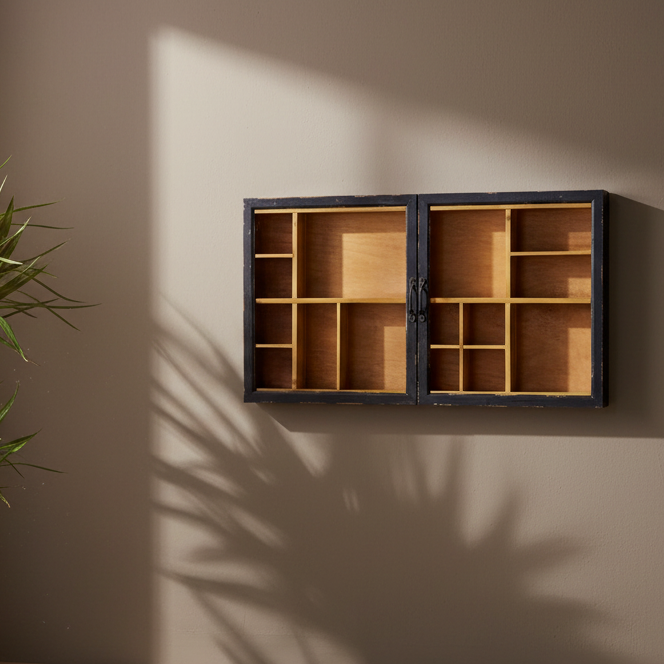 Wooden display case with glass doors on a beige wall