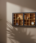 Wooden display cabinet with decorative items on a wall