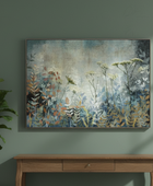 Framed abstract nature artwork on a green wall above a wooden console table.
