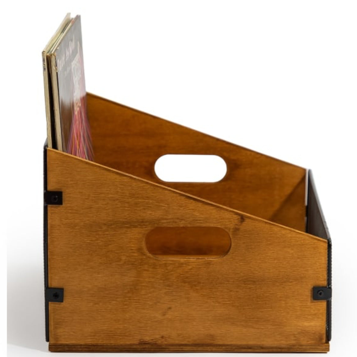 A wooden magazine rack with a warm medium-brown finish, featuring two oval cutouts for handles and black metal corner brackets, shown holding a few books on a white background.