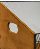 Close-up of a storage organizer with a warm brown wood panel featuring a cutout handle and black metal mesh sides.