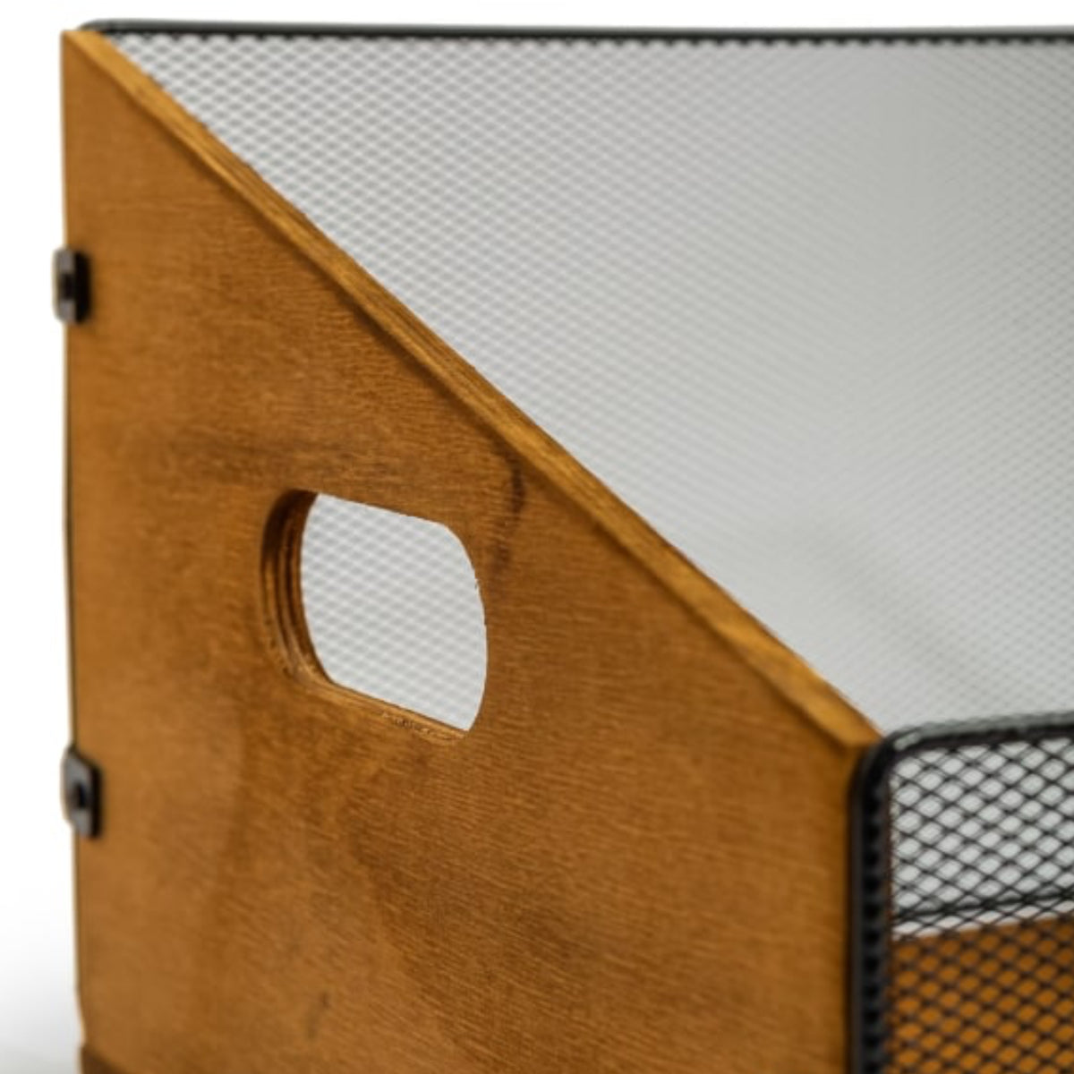 Close-up of a storage organizer with a warm brown wood panel featuring a cutout handle and black metal mesh sides.
