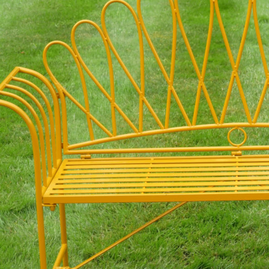Yellow metal bench on a grassy background