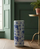 Tumbler with blue elephant design in a room with a window and plant