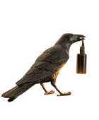Statue of a crow holding a bottle on a white background