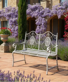 Decorative garden bench in front of a house with flowering plants