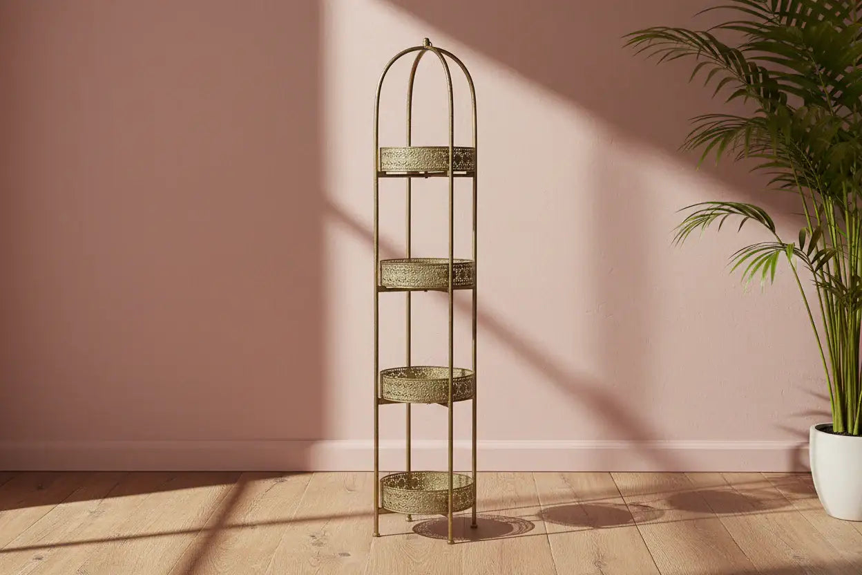 Decorative metal shelf against a pink wall with a plant on a wooden floor.