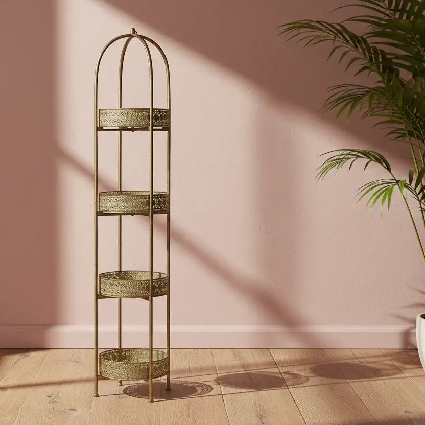 Tall, decorative metal shelf with three tiers against a pink wall.