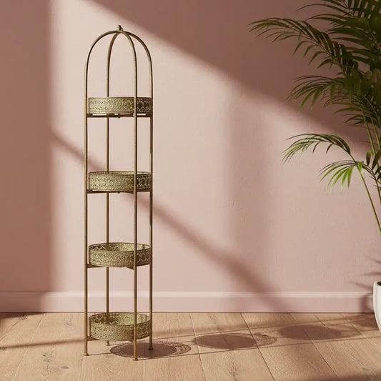 Tall, decorative metal shelf with three tiers against a pink wall.