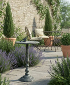 Outdoor patio setting with garden furniture and decorative table in a garden.