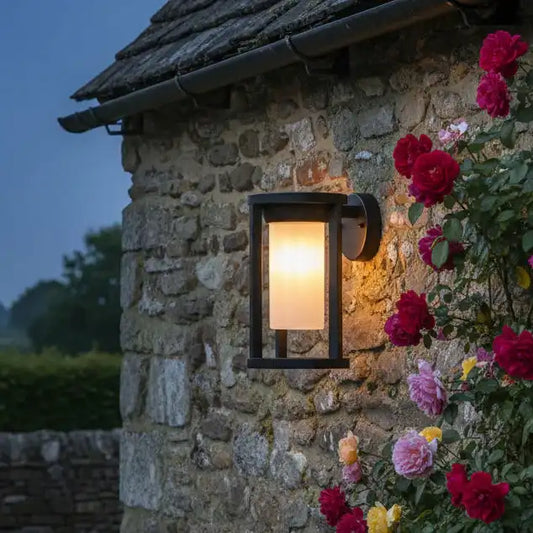 Stone wall with outdoor light fixture and flowers