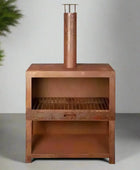 Copper barbecue grill on a gray background with green plants.