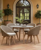 Outdoor patio set with round table and four chairs on a patio with plants and a building in the background.