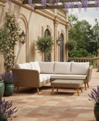 Outdoor patio with wicker furniture, potted plants, and a floral pergola.