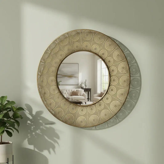 Round decorative mirror with circular patterns on a wall, reflecting a room with furniture.