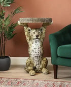 Decorative room with a green armchair, leopard statue, and potted plant on a brown wall background.