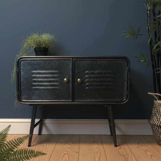 Black metal cabinet with gold handles against a dark blue wall with plants.