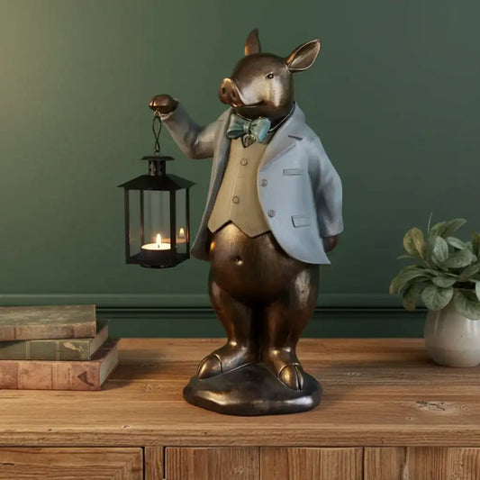 Decorative figurine of a rabbit in a suit holding a lantern on a wooden surface with a green wall background.