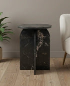 Black marble side table with a plant and chair in a room setting
