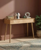 Wooden console table with decorative items on a white background