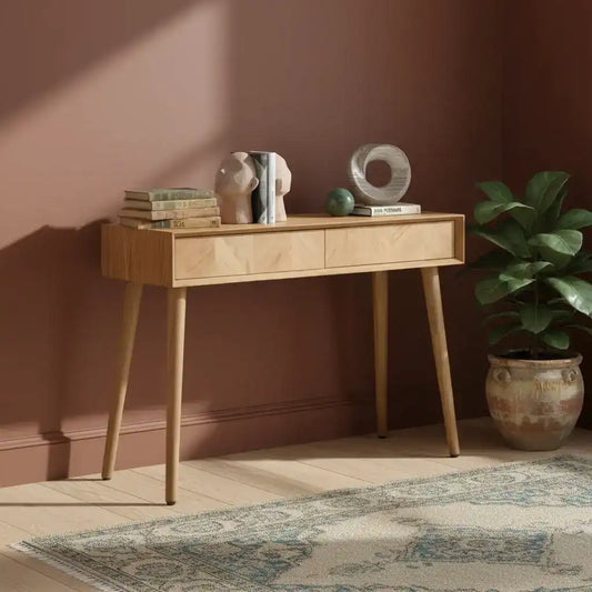 Wooden console table with decorative items on a white background