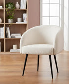 Beige armchair in a room with wooden floor and bookshelf