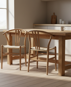 Wooden dining table with chairs in a bright room