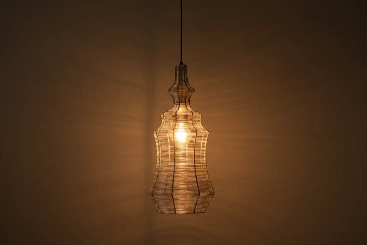 Decorative pendant light with a warm glow against a brown background