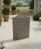 Outdoor patio with wicker planter, chairs, and scenic view