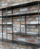 Black metal wall shelf against a brick wall background