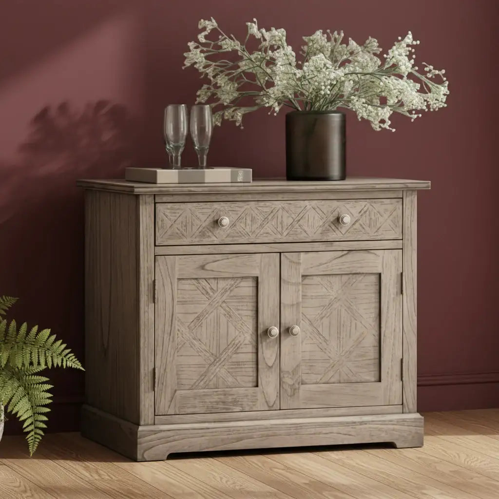 Wooden sideboard with decorative items against a maroon wall